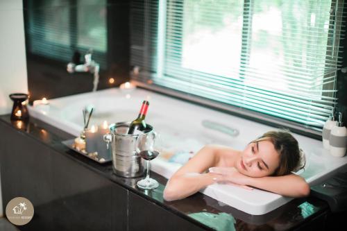 a woman is laying in a bath tub at Pak Nam Resort in Satun