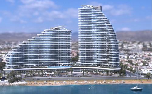 two tall buildings next to a body of water at Del Mar Beachfront Boutique Residence in Limassol