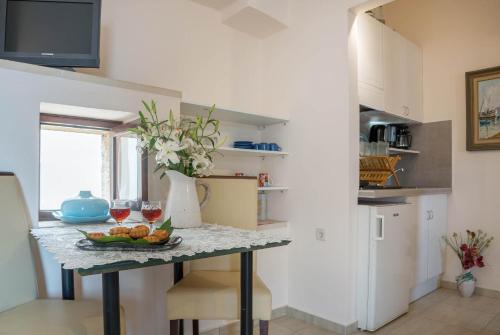 a kitchen with a table with two glasses of wine at Calergi Residence - Holidays in Crete in Atsipopoulo