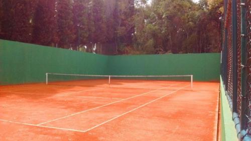 a tennis court with a tennis racket on it at Hotel Vista Azul ES in Domingos Martins