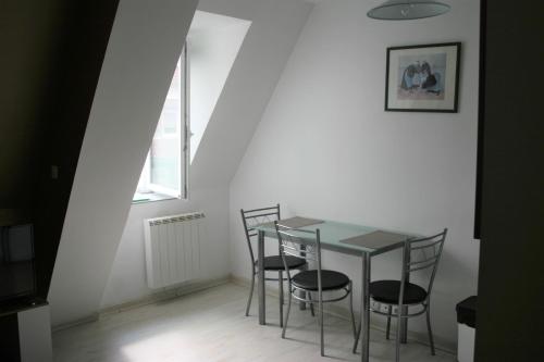 a table and chairs in a room with a window at studio9 in Ault