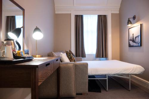 a hotel room with a bed and a couch at The Hawes Inn by Innkeeper's Collection in Queensferry