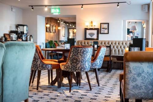 a restaurant with chairs and a table and a bar at The Hawes Inn by Innkeeper's Collection in Queensferry