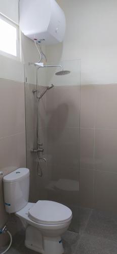 a bathroom with a toilet and a shower stall at Villa Kayana EE6 - 3 Bedrooms in Batu