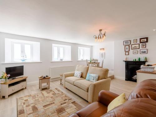 a living room with a couch and a tv at Pier Lookout in Eastbourne