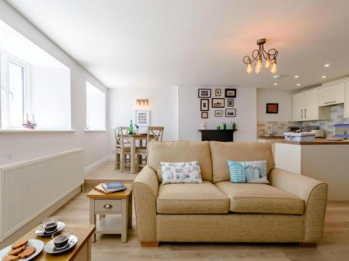 a living room with a couch and a kitchen at Pier Lookout in Eastbourne
