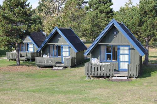 a row of cottages in a park at Nexø Camping & Cabins in Neksø