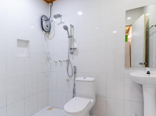 a bathroom with a shower and a toilet and a sink at Maafolhey Han'dhaan - Ukulhas in Ukulhas