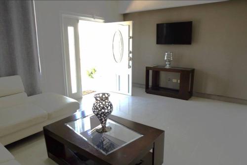 a living room with a couch and a coffee table at Beautiful house in Sabana Basora Aruba! in Savaneta