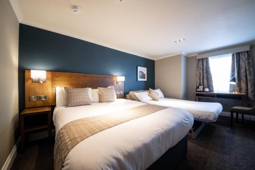 a hotel room with two beds and a window at Toby Carvery Strathclyde, M74 J6 by Innkeeper's Collection in Motherwell