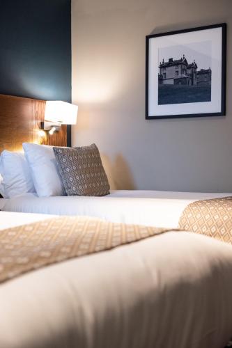 a hotel room with two beds and a picture on the wall at Toby Carvery Strathclyde, M74 J6 by Innkeeper's Collection in Motherwell