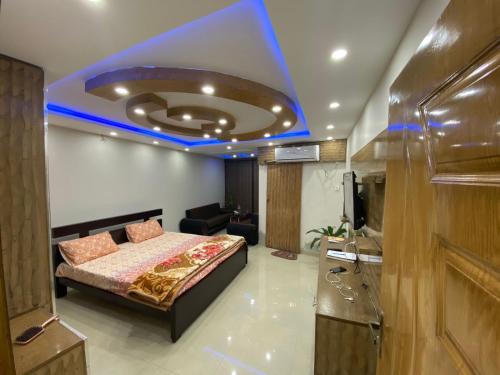 a bedroom with a bed and a blue ceiling at One bed lovely apartment in Rawalpindi