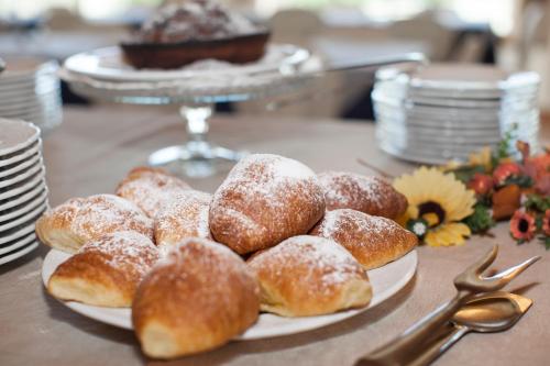 a plate of powdered donuts on a table at Hotel Spiaggia Marconi in Rimini