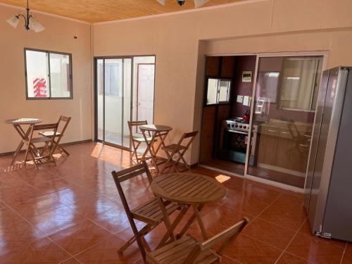 a room with chairs and a table and a refrigerator at HOSTAL SAIRI in San Pedro de Atacama