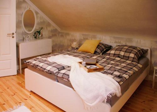 a bedroom with a bed with a blanket on it at Petite Maison in Püttlingen