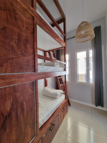 a room with two bunk beds and a window at Compass House in Las Palmas de Gran Canaria