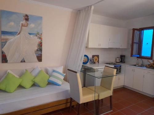 a living room with a couch and a glass table at Calergi Residence - Holidays in Crete in Atsipopoulo