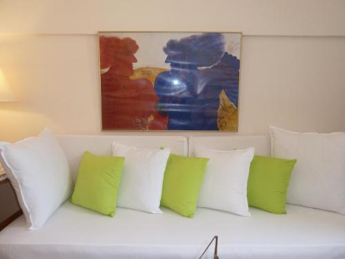 a white couch with green and white pillows at Calergi Residence - Holidays in Crete in Atsipopoulo