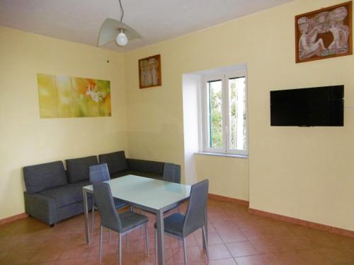 a living room with a table and a couch at Blue Lagoon in Amalfi