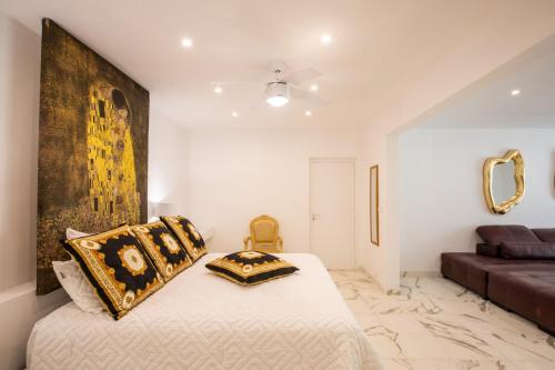 a bedroom with a bed with a large painting on the wall at 5 BR Luxurious Beachfront Villa with utmost privacy in Les Terres Basses