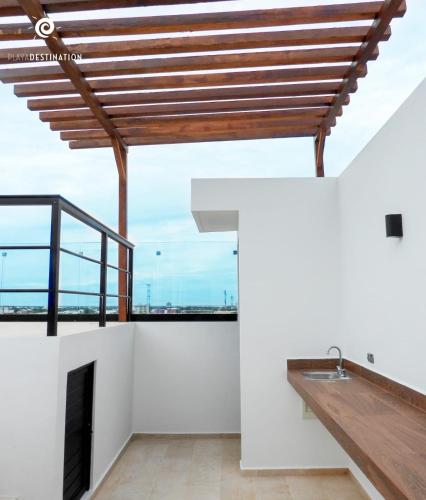 a room with white walls and a wooden ceiling at Suites calle 38 in Playa del Carmen