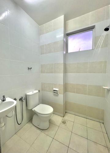 a bathroom with a toilet and a sink at SuaTamu Homestay One Aircond in Kamunting