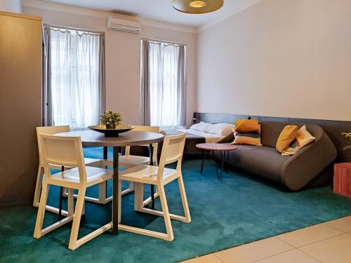 a living room with a table and a couch at Apartments Cilindar in Zagreb