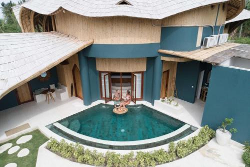 an aerial view of a house with a swimming pool at Villa Tokay - Luxury Private Villas in Gili Islands
