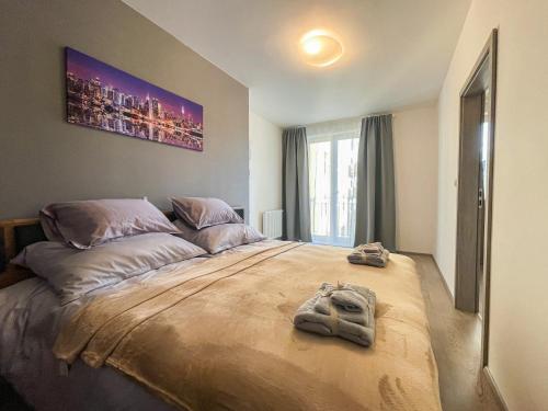 a bedroom with a bed with towels on it at Apartments / 10 min from center / O2 ARENA in Prague