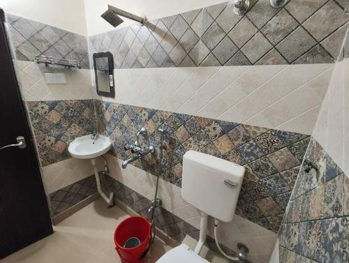 a bathroom with a toilet and a sink at Lavish 2BHK, 10 mins from AMRI Hospital Dhakuria in Kolkata