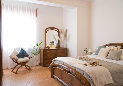 a bedroom with a bed and a dresser and a window at Iris Apartment, Parco Velino Sirente in Celano