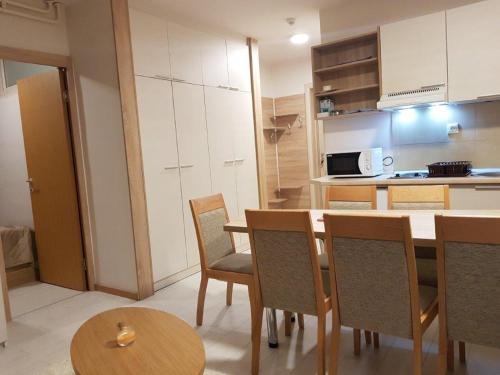 a kitchen with a table and chairs in a room at Snow White apartments in Kopaonik