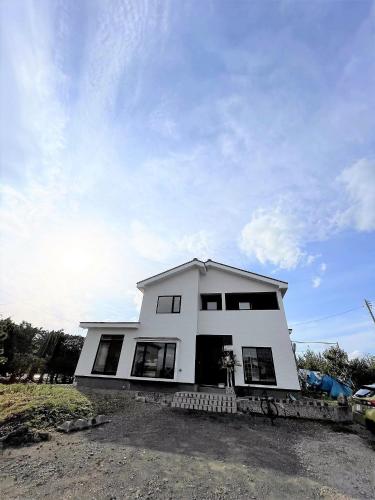 a white house with a lot of windows at HIROSAKI清水森はうす in Hirosaki