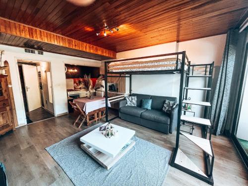 a living room with a bunk bed and a couch at Grand Studio « Ô Soleil » 4 pers. 200m des pistes. in La Salle Les Alpes