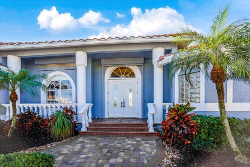 a blue house with a palm tree in front of it at Marco Paradise in Marco Island