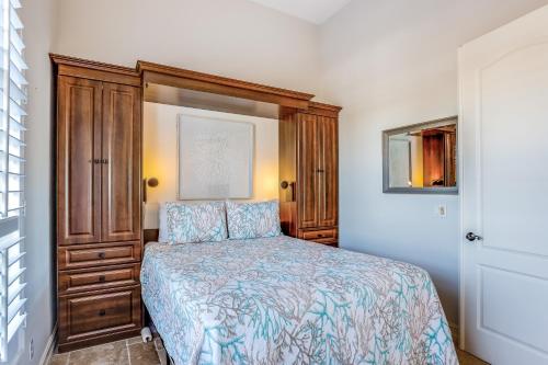 a bedroom with a bed and a wooden cabinet at Marco Paradise in Marco Island