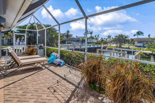 a patio with a bench and a view of the water at Marco Paradise in Marco Island
