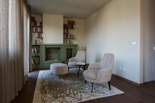 a living room with two chairs and a table at AlbaResidence Vico01 in Alba