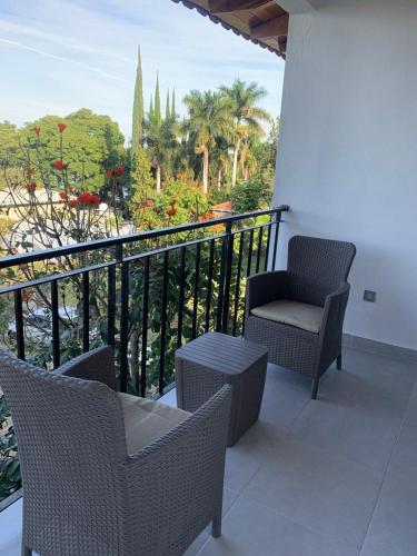 a balcony with chairs and a chair on a balcony at CASA RIVERA DE MORAS in San Luis Soyatlán