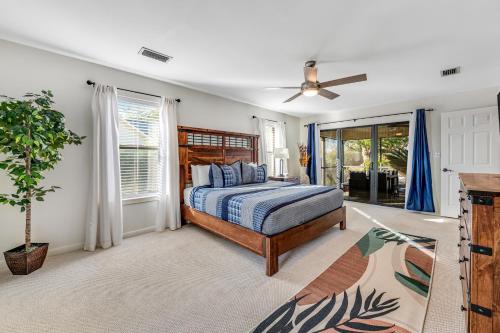 a bedroom with a bed and a ceiling fan at Outdoor Oasis by Beaches in Gulf Breeze
