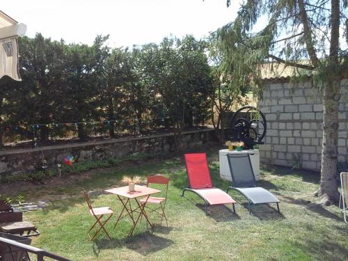 a group of chairs and a table in a yard at Maison de ferme rénovée avec terrasse, jardin et équipements modernes à Taxat-Senat - FR-1-489-363 in Taxat-Senat