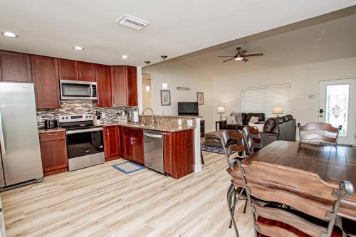a kitchen and living room with a table and a dining room at Heather Lakes Retreat in Brandon