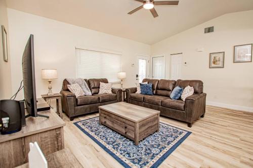 a living room with two couches and a flat screen tv at Heather Lakes Retreat in Brandon