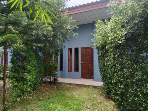 a small blue house with a wooden door at Navara Resort 