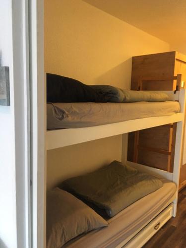 two bunk beds in a room with at Studio 1 cabine chalet club III refait à neuf in Tignes