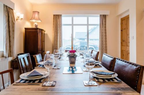 een lange tafel met wijnglazen en een raam bij Beachcombers in Kent