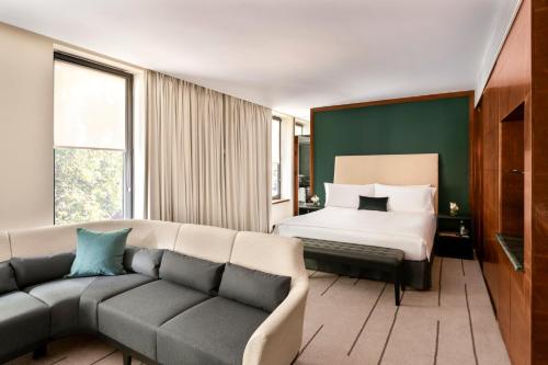 a living room with a couch and a bed at COMO The Halkin in London