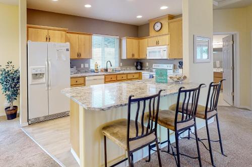 a kitchen with a large island with bar stools at Sittin' By The Sea in Pacific City