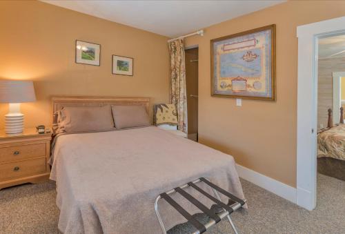 a bedroom with a bed and a chair in it at Meranova Guest Inn in Dunedin