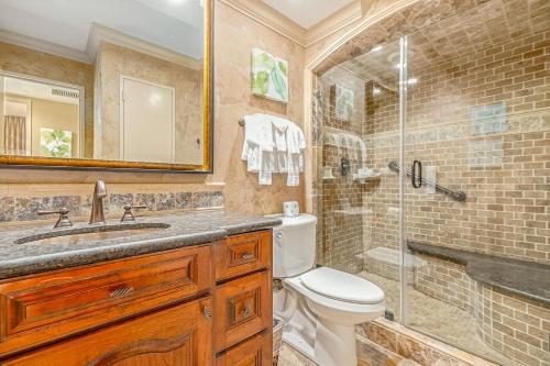 a bathroom with a toilet and a shower and a sink at Gulf Overlook San Luis Resort 1035 in Galveston